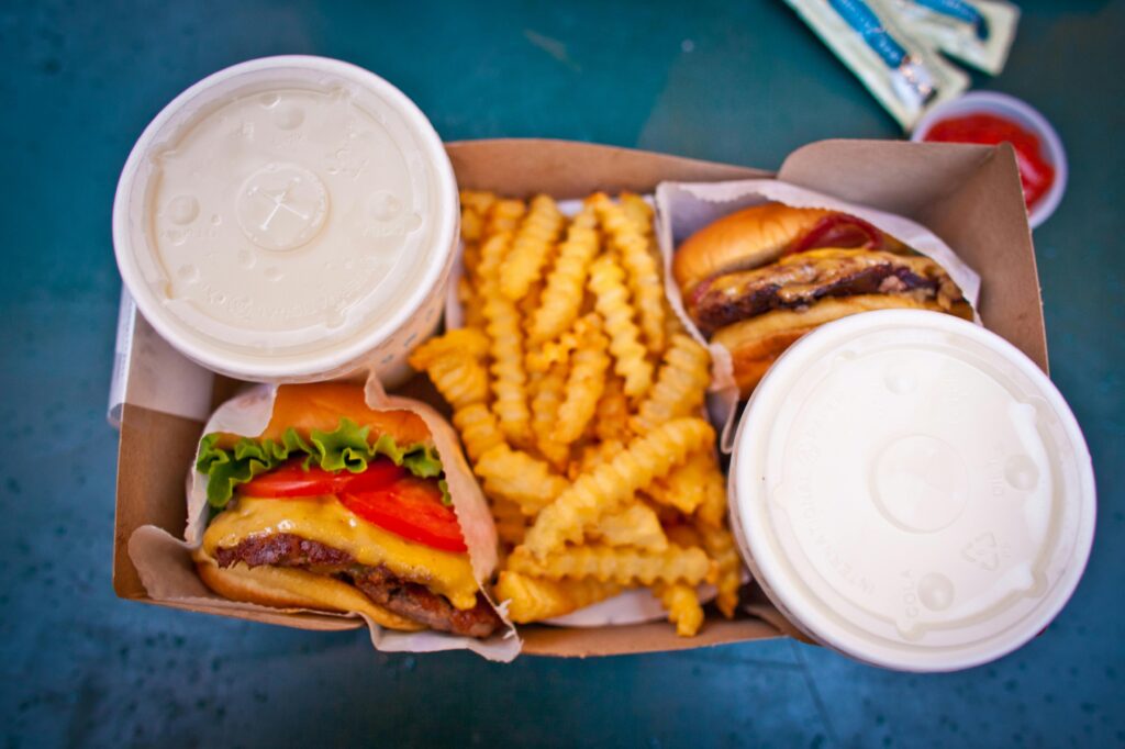 A burgers and fries in a cardboard box