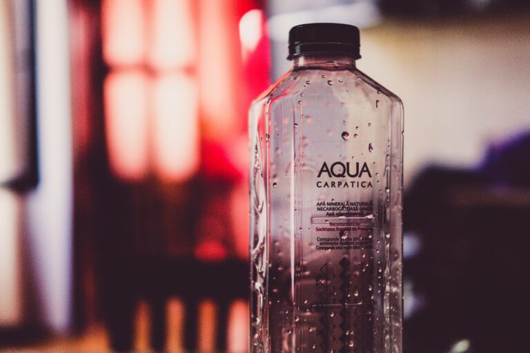 A clear plastic bottle with water drops