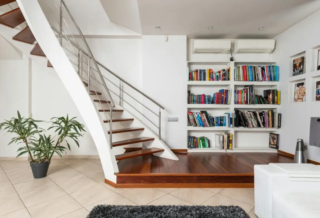 A staircase with bookshelves in a room