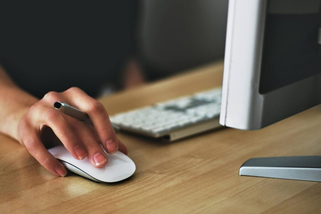 Small business branding on a budget: how to build a strong visual identity professional website for tradespeople A hand holding a mouse, small business branding