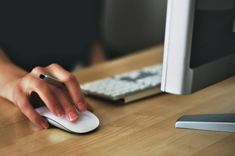 A hand holding a mouse, small business branding